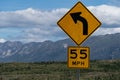 55 miles per hour speed limit on curve sign on a United States h Royalty Free Stock Photo