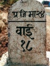 Milestone showing ward number of a village at a rural Indian road