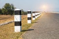 Milestones, black and white milestones with green grass roadside, Royalty Free Stock Photo