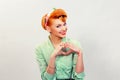 Miling cheerful happy young pin up woman making heart sign with hands Royalty Free Stock Photo