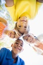 miling children forming a huddle in circle