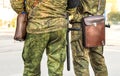 Militaries legs with security truncheons and officers bag.