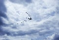 Military airplanes flying in V formation with blue sky and cloudy day at background