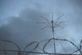 Military antenna. Radio electronic troops. Guarded object, barbed wire fence Royalty Free Stock Photo