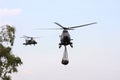 Military Apache is guiding a Cougar transport heli Royalty Free Stock Photo