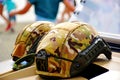 military or army helmets in closeup view. canvas camouflage color jacket cover on top