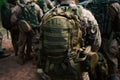 military backpack, surrounded by group of soldiers, preparing for battle Royalty Free Stock Photo
