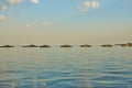 Military Battleships in a sea bay at sunset time.