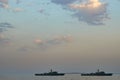 Military Battleships in a sea bay at sunset time