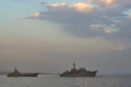 Military Battleships in a sea bay at sunset time