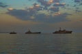 Military Battleships in a sea bay at sunset time