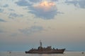 Military Battleships in a sea bay at sunset time