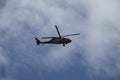Military black hawk helicopter flying over crow during colombian independence day with blue sky