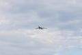 Military bomber aircraft flying in the cloudy sky in daylight