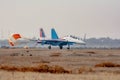 A military plane landed on the ground with an open parachute. Bomber plane made landing at the airport Royalty Free Stock Photo