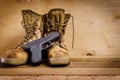Military boots and gun on the table