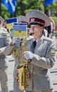 Military brass band. Female saxophone, performer