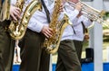 military brass band playing saxophones and trombones during music fest Royalty Free Stock Photo