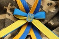 Military camouflage fabric with ukrainian stripes on ribbon