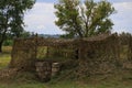 Military camouflaged dugout leading to an underground bunker