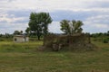 Military camouflaged dugout leading to an underground bunker