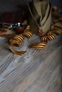 Military cap, carnations, Saint George ribbons, flask with alcohol on a wooden surface