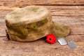 Military cap, red poppy and dog tags.