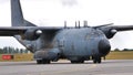 Military cargo aircraft taxiing on the runway close view