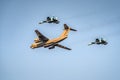 Cargo plane escorted by two fighter planes Royalty Free Stock Photo