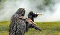 Commando dressed in ghillie camouflage during combat warfare