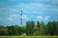 Military communications tower with various communication equipments and antennas for radio and 5G inside a forest