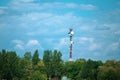 Military communications tower with various communication equipments and antennas for radio and 5G inside a forest