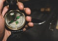 Military compass in hand. Bushcrafters holding the compass in hand on background of the knife and flint. survival in extreme Royalty Free Stock Photo