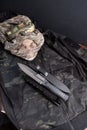 Military composition of objects. Military knife on a camouflage jacket. Knife and skull in panama. Royalty Free Stock Photo