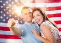 Military Couple Holding House Keys In Front of American Flag Royalty Free Stock Photo