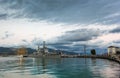 Military cruiser and sailing boat moored at the dock Royalty Free Stock Photo