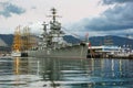 Military cruiser and sailing boat in Novorossiysk port Royalty Free Stock Photo