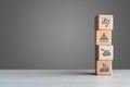 Military defence icons on wood bricks stacked on a table with grey background