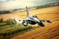 Military F16 fighter jet close up flying through the air over blue sky and yellow fields landscape. Fighter armed with rockets and