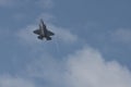 Military F35 fighter jet flying. Blue sky with clouds. Lockheed Martin F-35B `Lightning` II Royalty Free Stock Photo