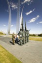 Military family look at Bronze Honor Guard and three soaring spires of the Air Force Memorial, Arlington, Virginia in Washington