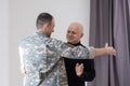 Military father hugs his son when they are reunited after a mission