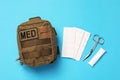 Military first aid kit on light blue background, flat lay Royalty Free Stock Photo