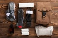 Military first aid kit. Medical tourniquet to stop the blood, alcohol, bandages and cotton wool on a brown textured wood. Royalty Free Stock Photo