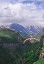 Paraglider against the backdrop of the Caucasian mountains. Military Georgian road. Beautiful places in Kazbegi district Royalty Free Stock Photo