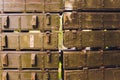 Military green boxes with dangerous explosives, guns and military weaponry, ready for shipping, in a munition producing