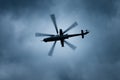 Military gunship helicopter on the stormy sky. Royalty Free Stock Photo