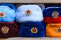 Military hats ushanka of different colors with the USSR coat of arms and red stars as Souvenirs from Moscow