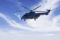 Military helicopter is hovering in the blue sky Royalty Free Stock Photo