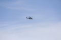 Military helicopter. Italian military helicopter in the sky. Military helicopter against the background of a blue sky.